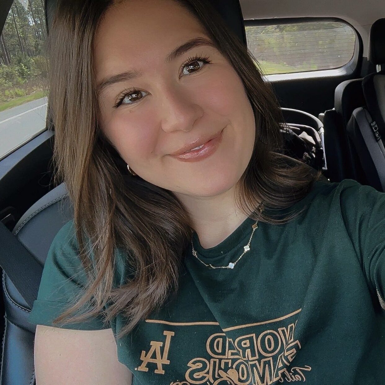 original-120F4D73-391D-432B-8480-C49508C6FF0E A woman sitting in the back of a car.